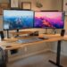 1. Modern height-adjustable standing desk in home office with dual monitors and ergonomic accessories