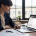 Entrepreneur reviewing business loan application documents on laptop without collateral requirements
