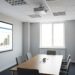 compact office projector displaying presentation in small meeting room